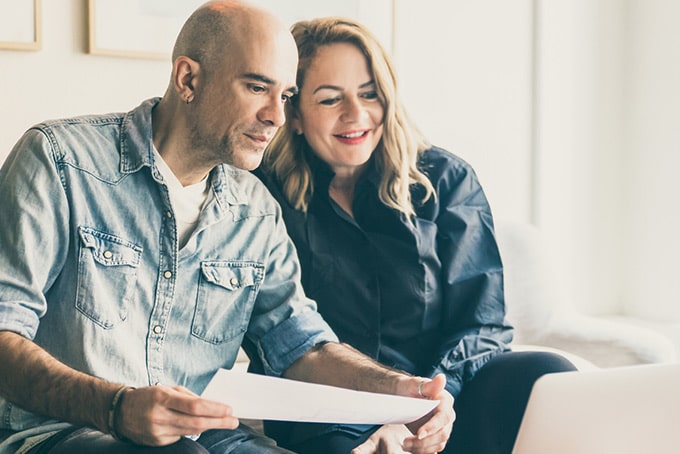 a couple reads their minimum payment disclosure together