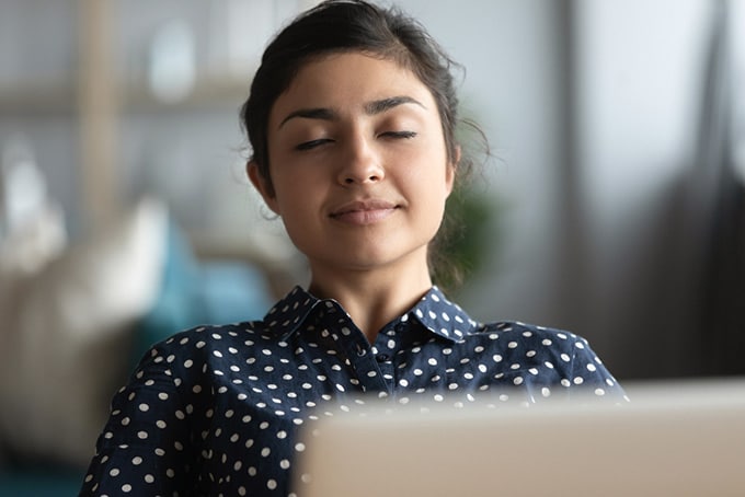 woman breathing a sigh of relief after rebuilding her emergency fund