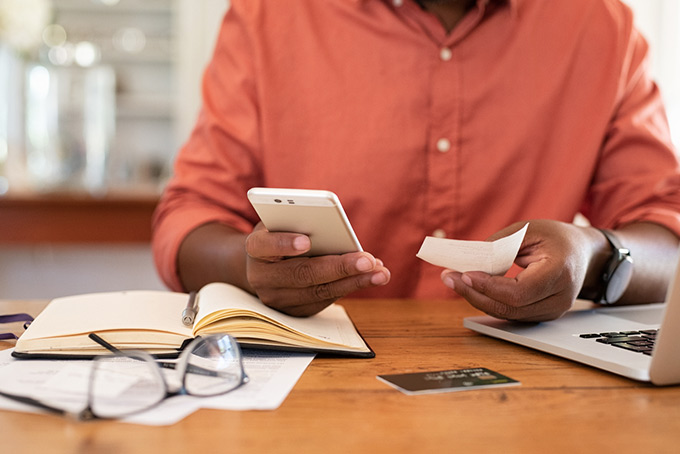 man using an app to manage his budget