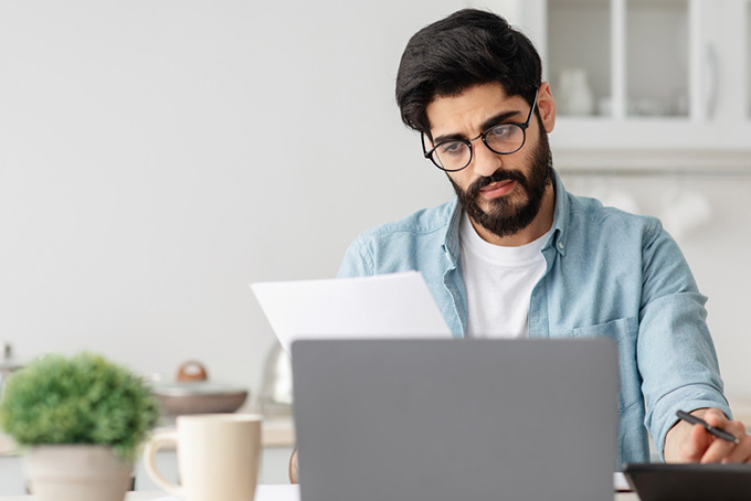 man reviewing his credit card statement