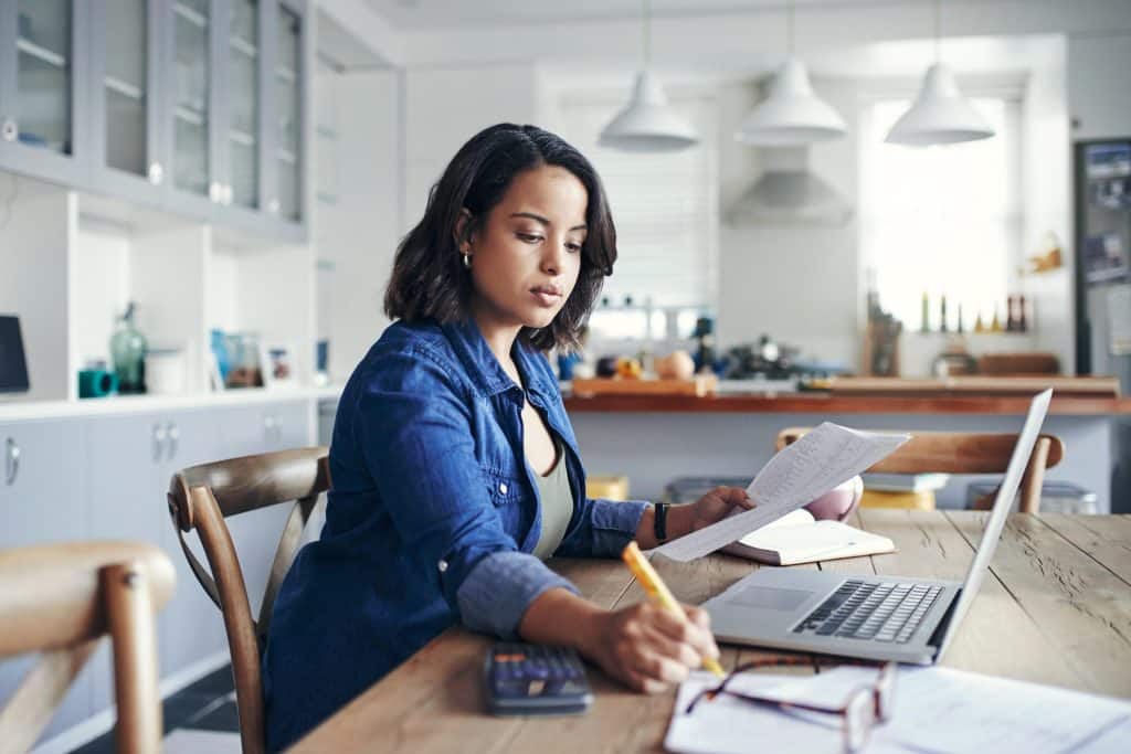 Person reviewing medical bills and insurance paperwork at home